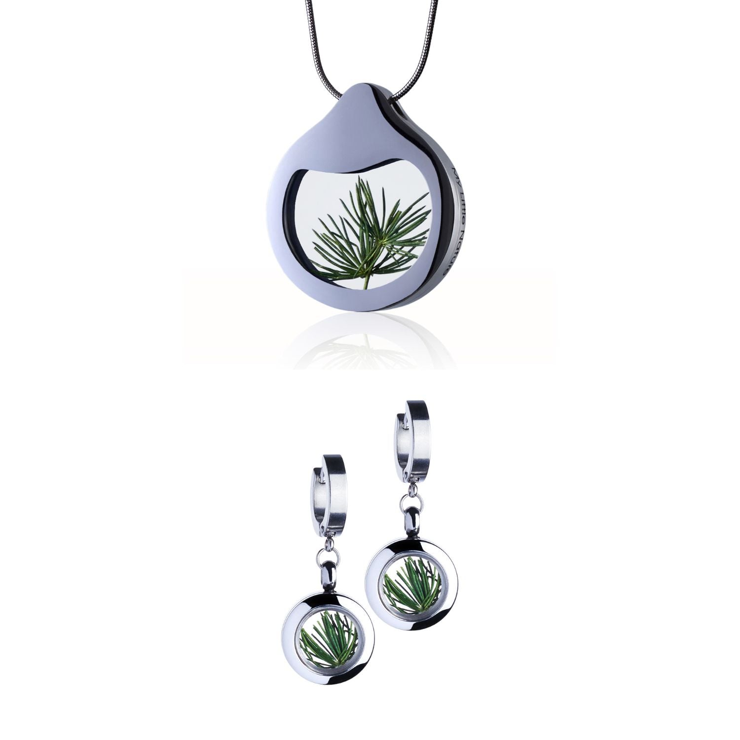 Pine Needles Jewelry Set with a designer necklace by Barbora-Adamonyte Keidune and dangle huggie earrings in stainless steel, featuring real pine needles under glass. Symbolizes eternal vitality and boundless optimism.