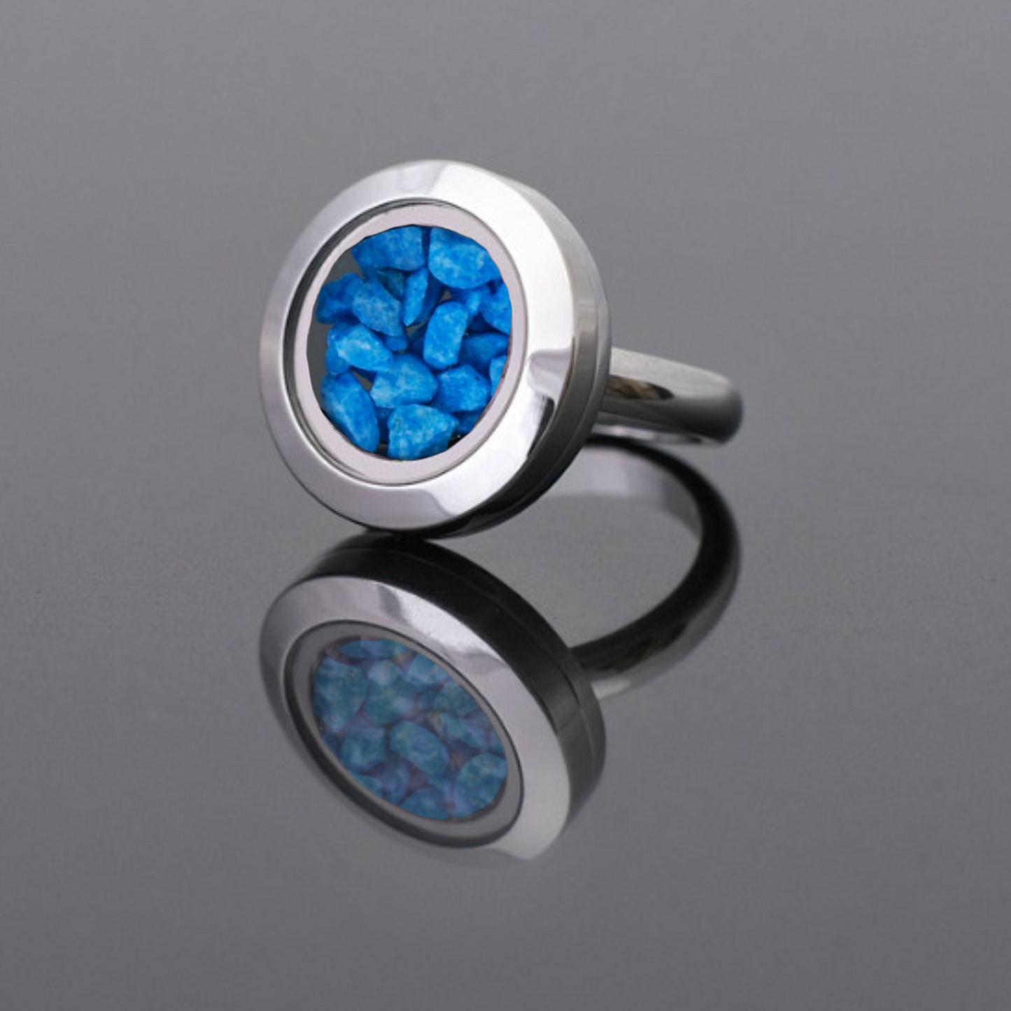 Handmade statement ring with vibrant blue stones set in a stainless steel band, inspired by the tranquility of the ocean and sky.