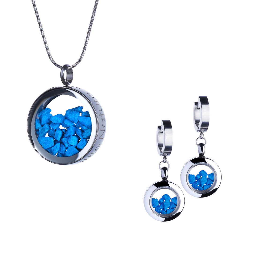 Blue Stones Jewelry Gift Set featuring dangle huggie earrings and a magnified nature necklace in stainless steel, with vibrant blue stones under glass. Symbolizes clarity, confidence, and inner strength.