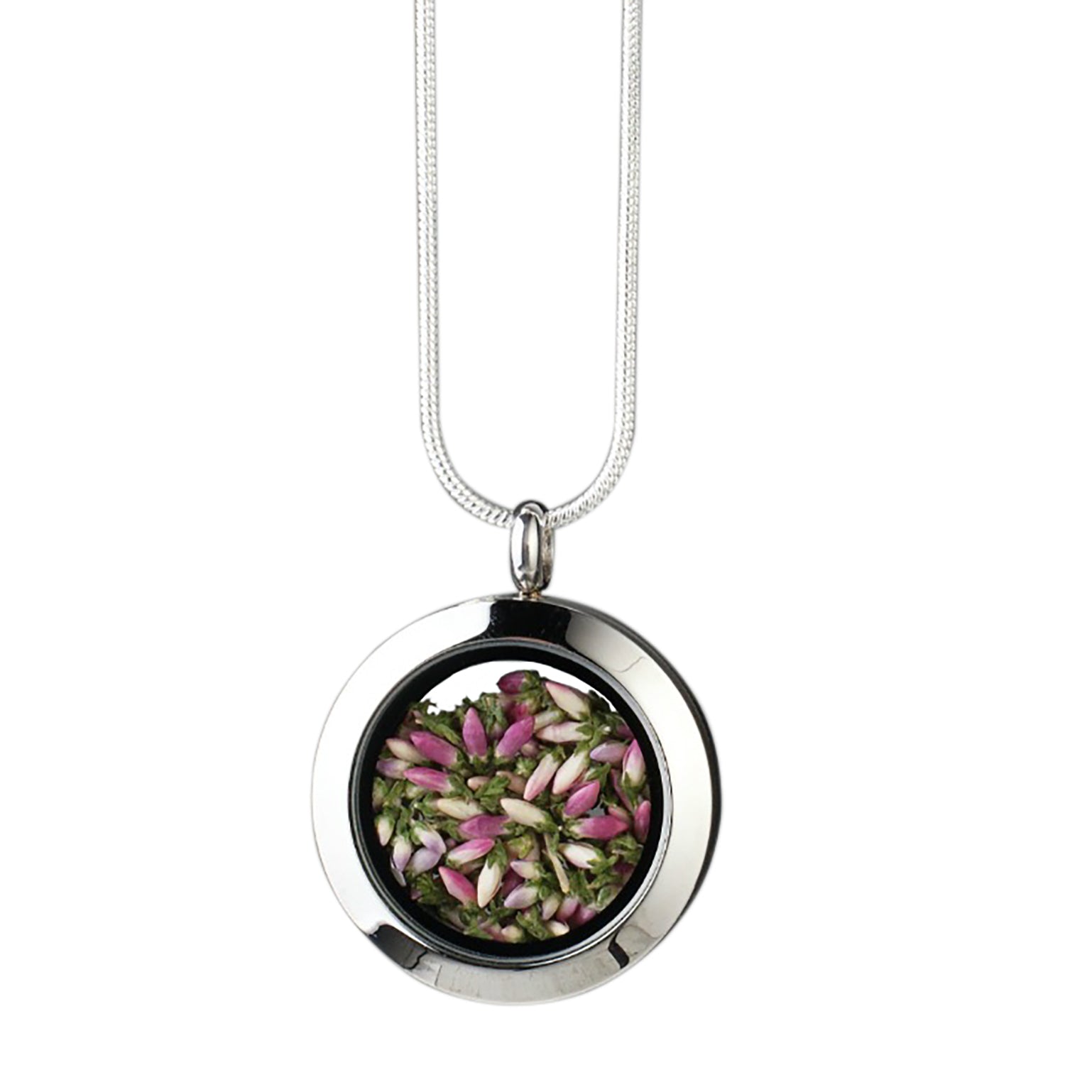 Handmade heather amulet with real heather encased in glass, set in stainless steel.