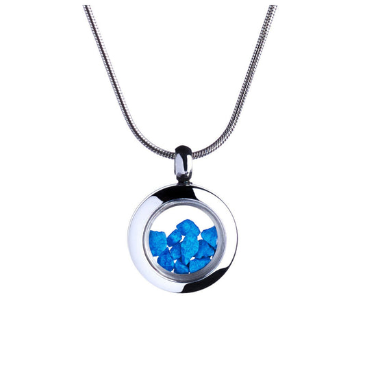 A striking blue glass pendant hanging from a silver chain, highlighting the contrast between the two materials