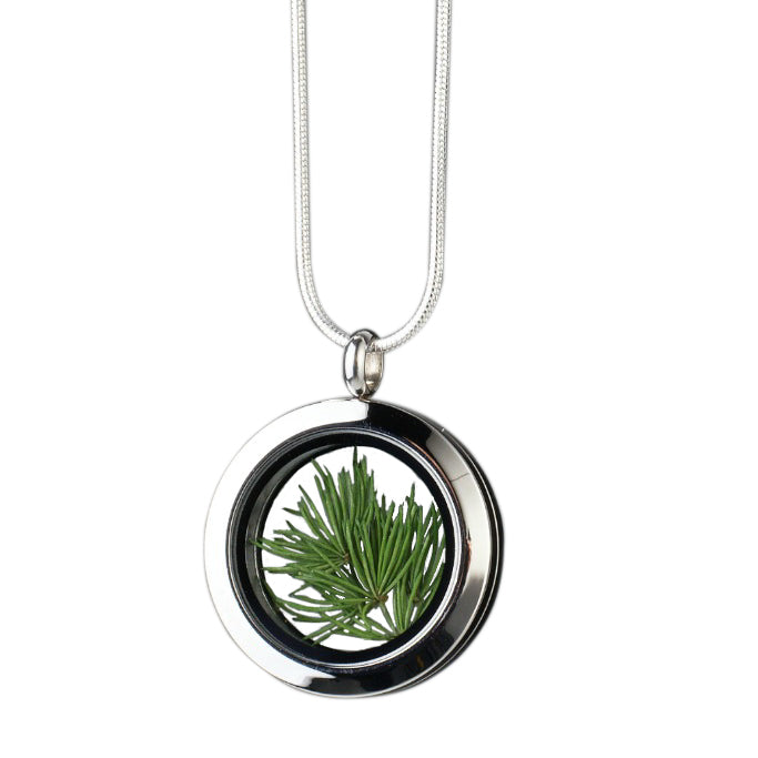 Handmade Pine Needles Amulet with genuine pine needles encased in glass and set in stainless steel, symbolizing eternal youth, vitality, and boundless energy.