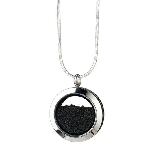 Handmade Volcanic Sand Amulet with genuine volcanic sand encased in glass and set in stainless steel, symbolizing strength, resilience, and the transformative power of nature.