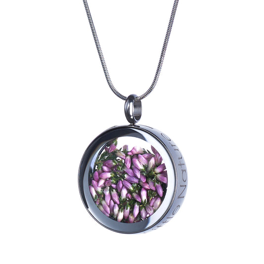 Handmade magnified heather flower necklace featuring real heather under a glass lens, symbolizing strength, resilience, and perseverance. Nature-inspired jewelry piece.