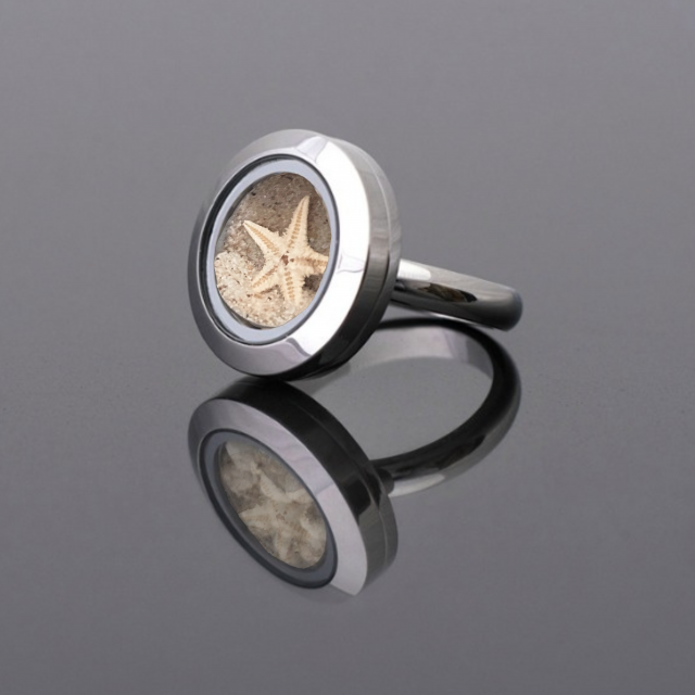 Handmade statement ring with real natural starfish and beach sand preserved under glass, set in a stainless steel band, symbolizing healing and serenity.