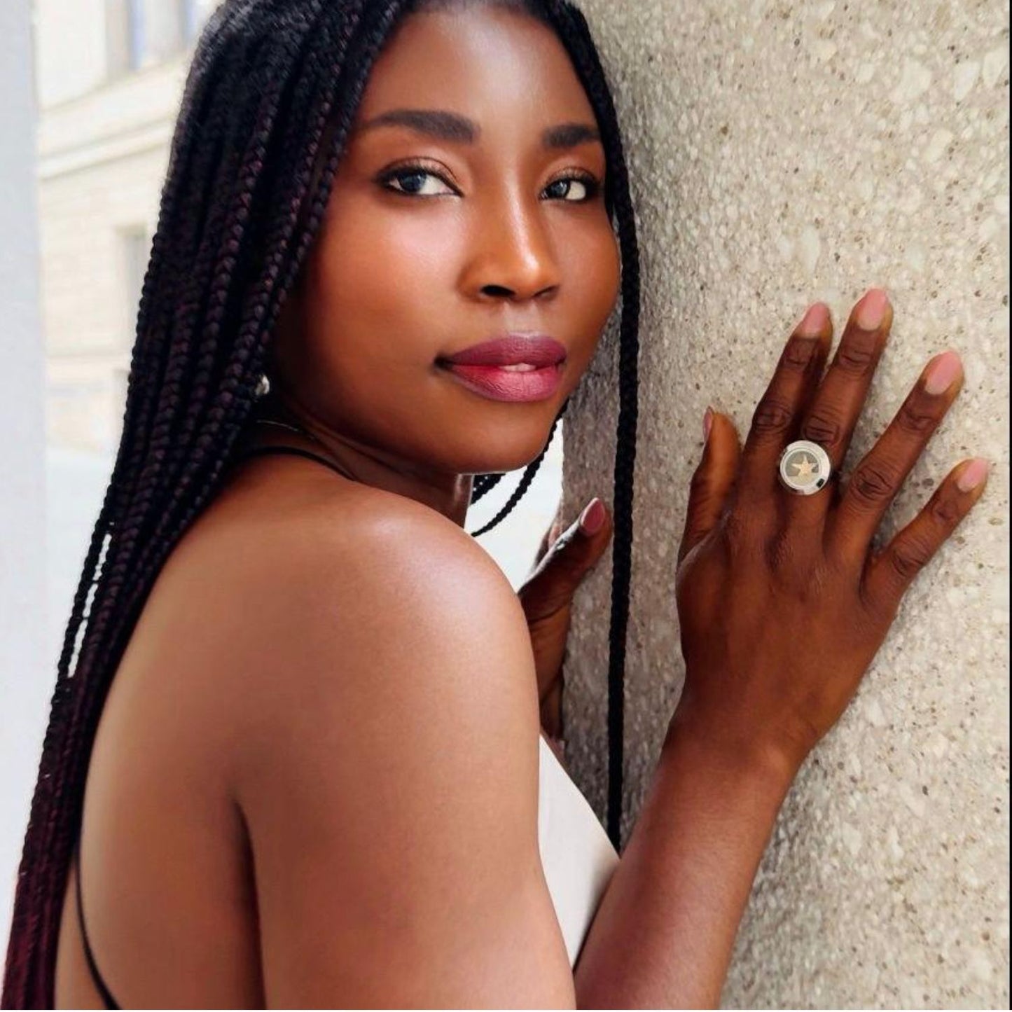 model wearing starfish and sand ring on her finger